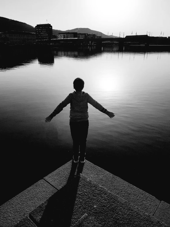 a person standing on the dock near water