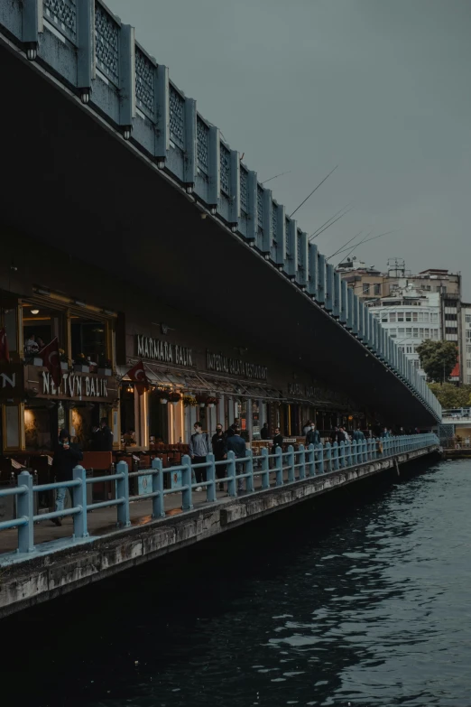 a restaurant on the side of a boat near water