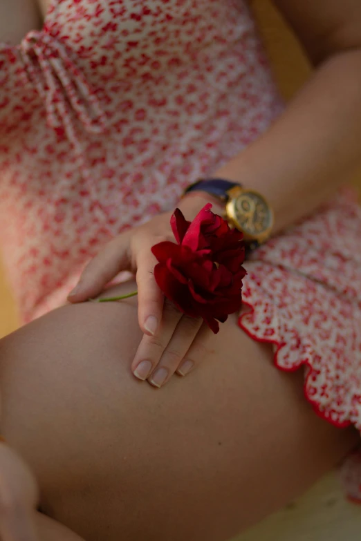 a belly close up of a woman with a rose on her right stomach
