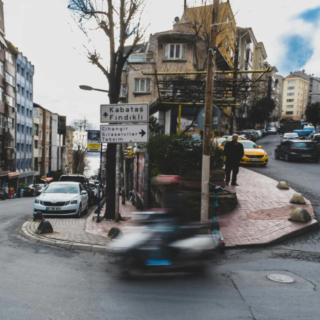 a car parked on a city street next to a traffic light