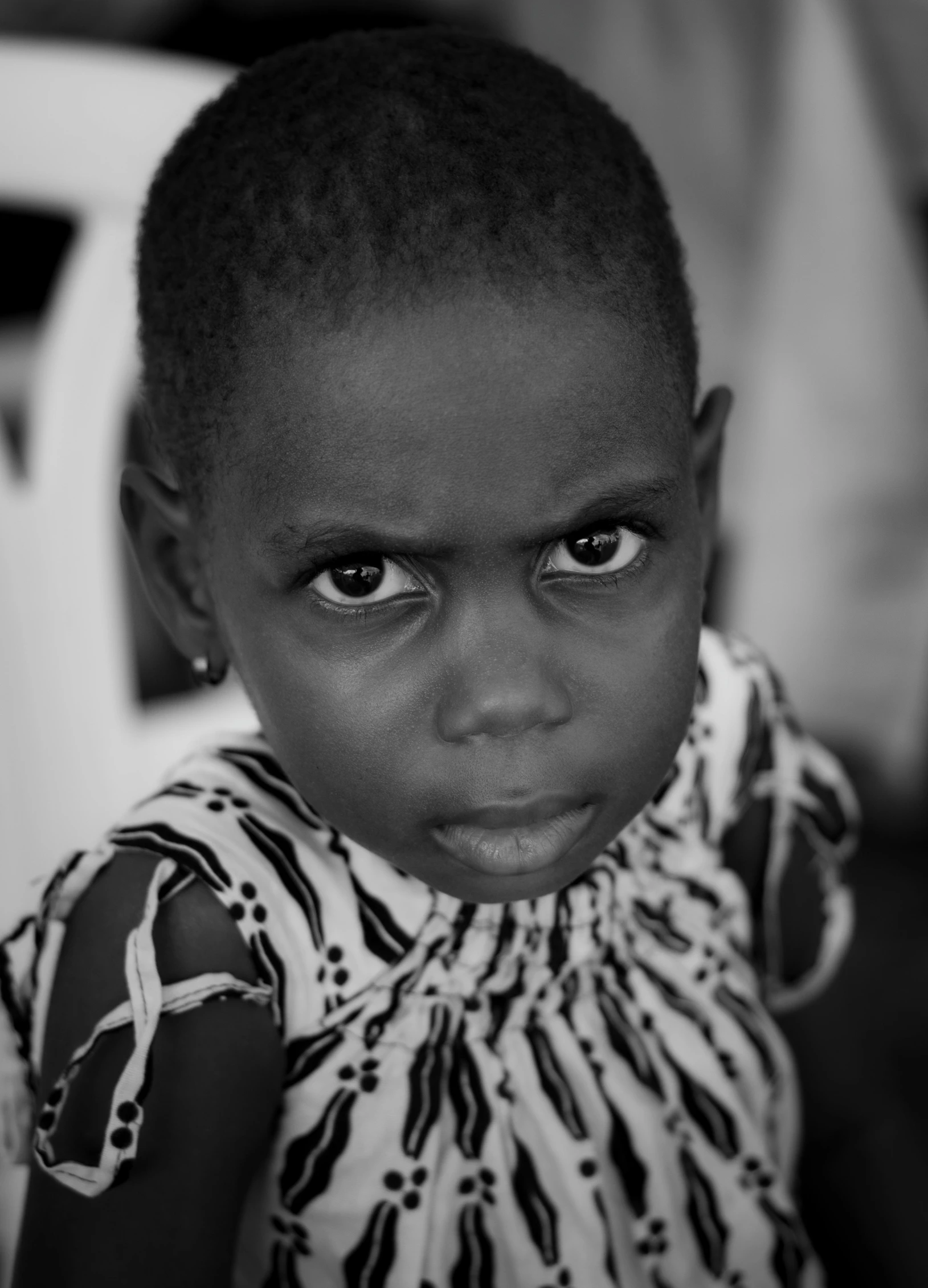 black and white image of small child wearing a shirt