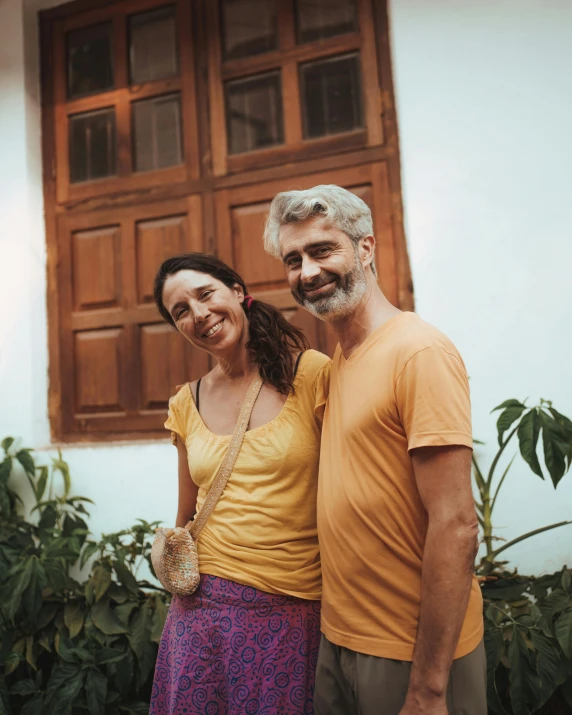 two people are standing in front of a window