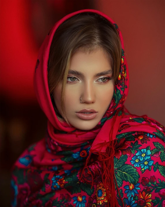 a woman wearing red shawl and head scarves