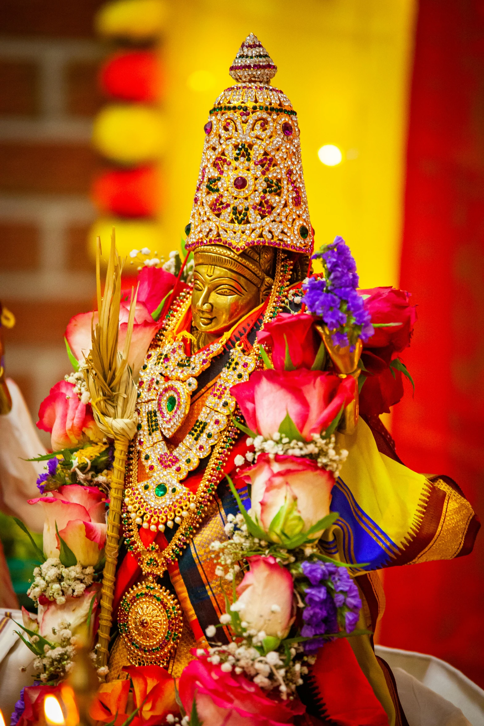 a ganesh idol being carried by a priest