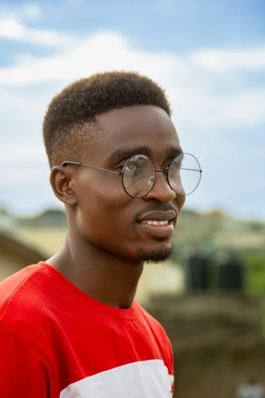 young man in a red shirt with a pair of glasses