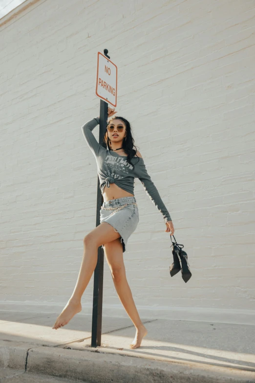 a woman holding onto a pole posing for a picture