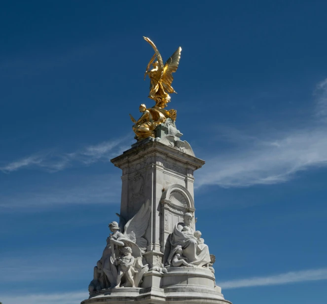 the statue is in front of the large blue sky