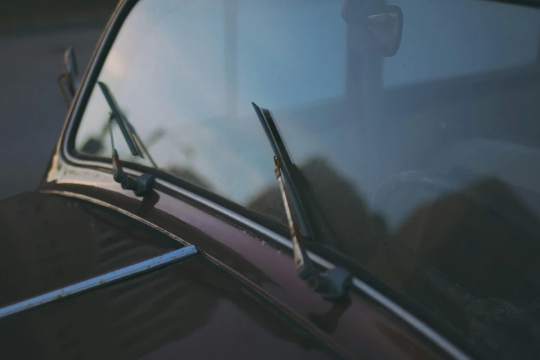 the old car is sitting parked at the side of the street