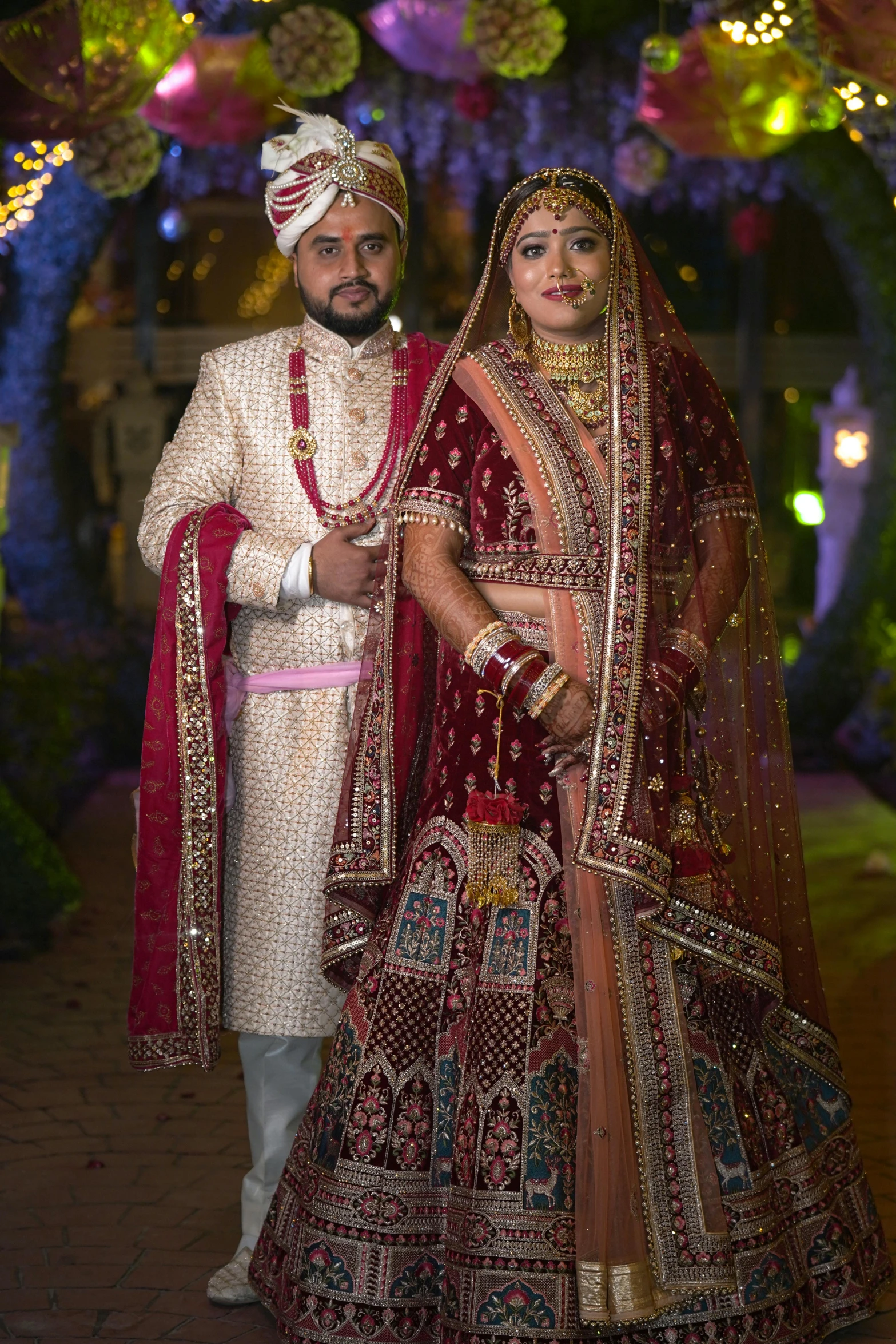 an indian bride and groom in traditional wedding attire