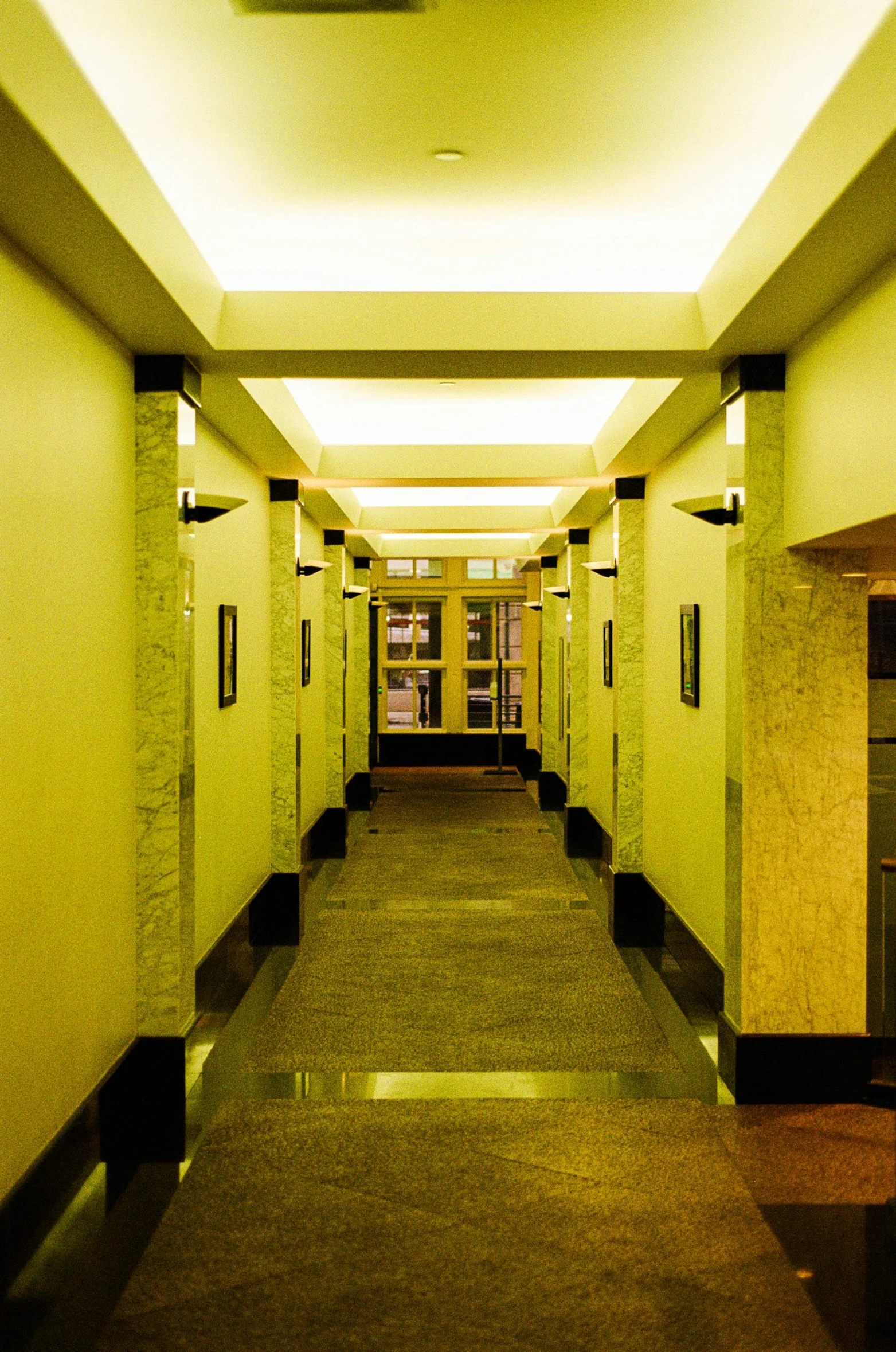 long hallway leading to elevators of residential building