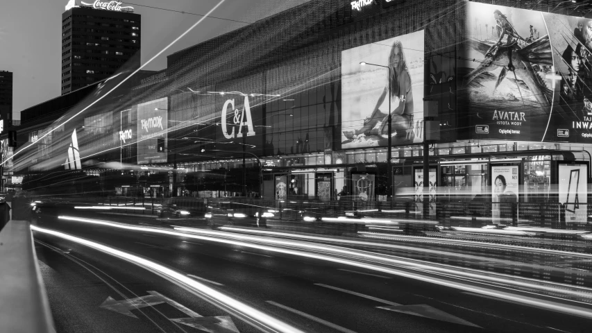 a large building with advertits on it at night