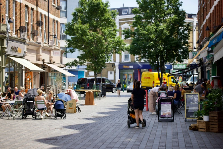 people walking in the street in front of shops and stores