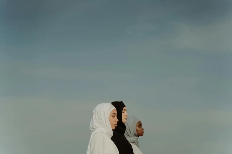 a muslim couple looks up at a blue sky