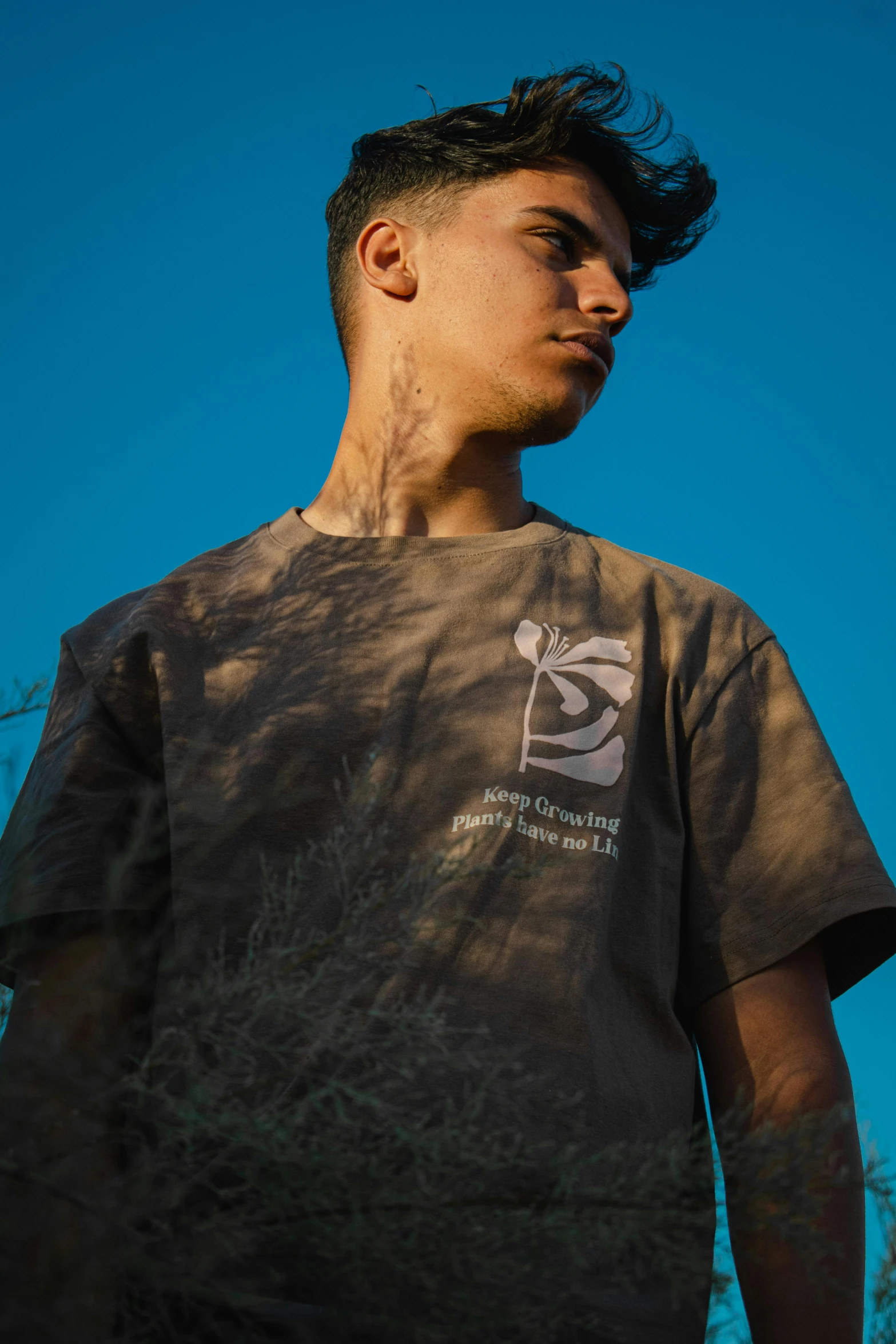 a young man with a weird shirt holding a skateboard