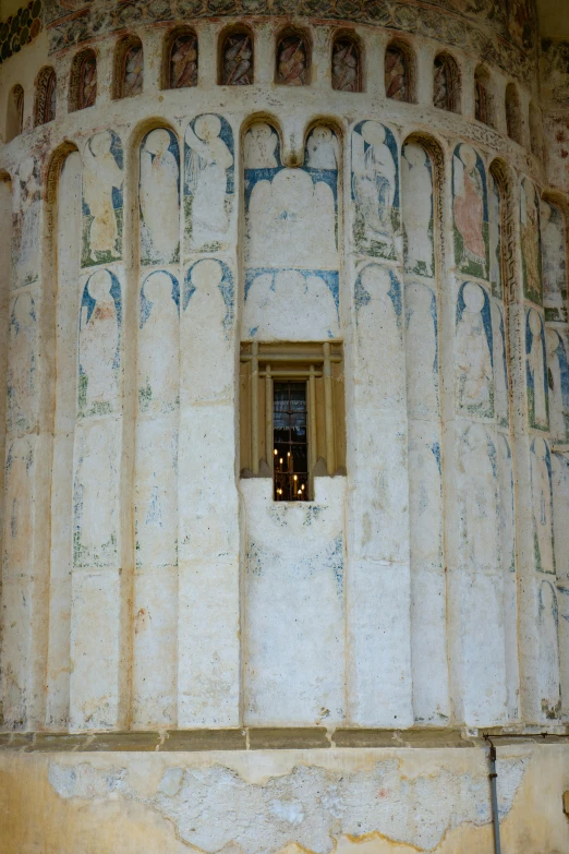 an abstractly painted tower structure with a small window