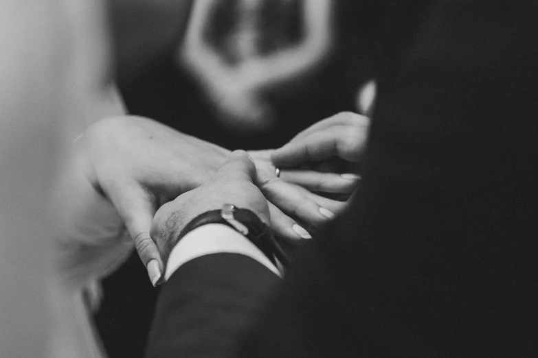 a bride and groom hold hands together as they look at each other