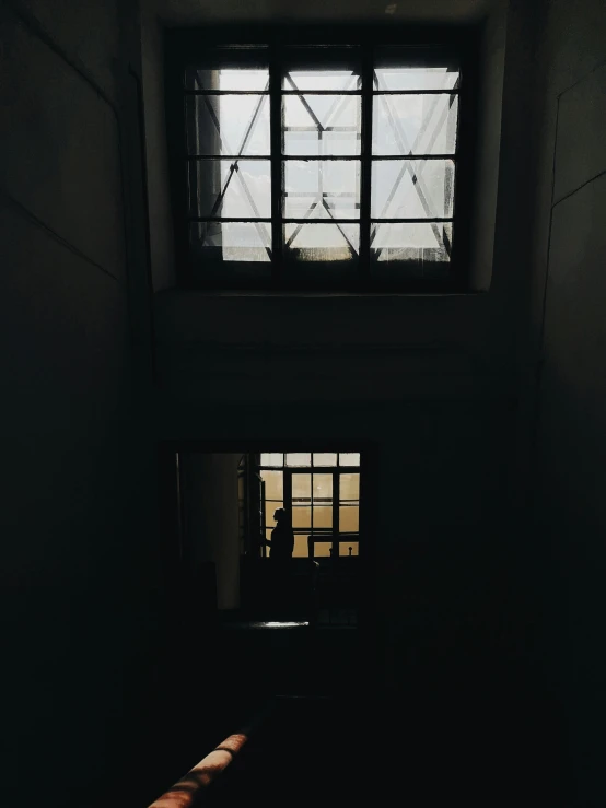 a window next to a door is shown at night
