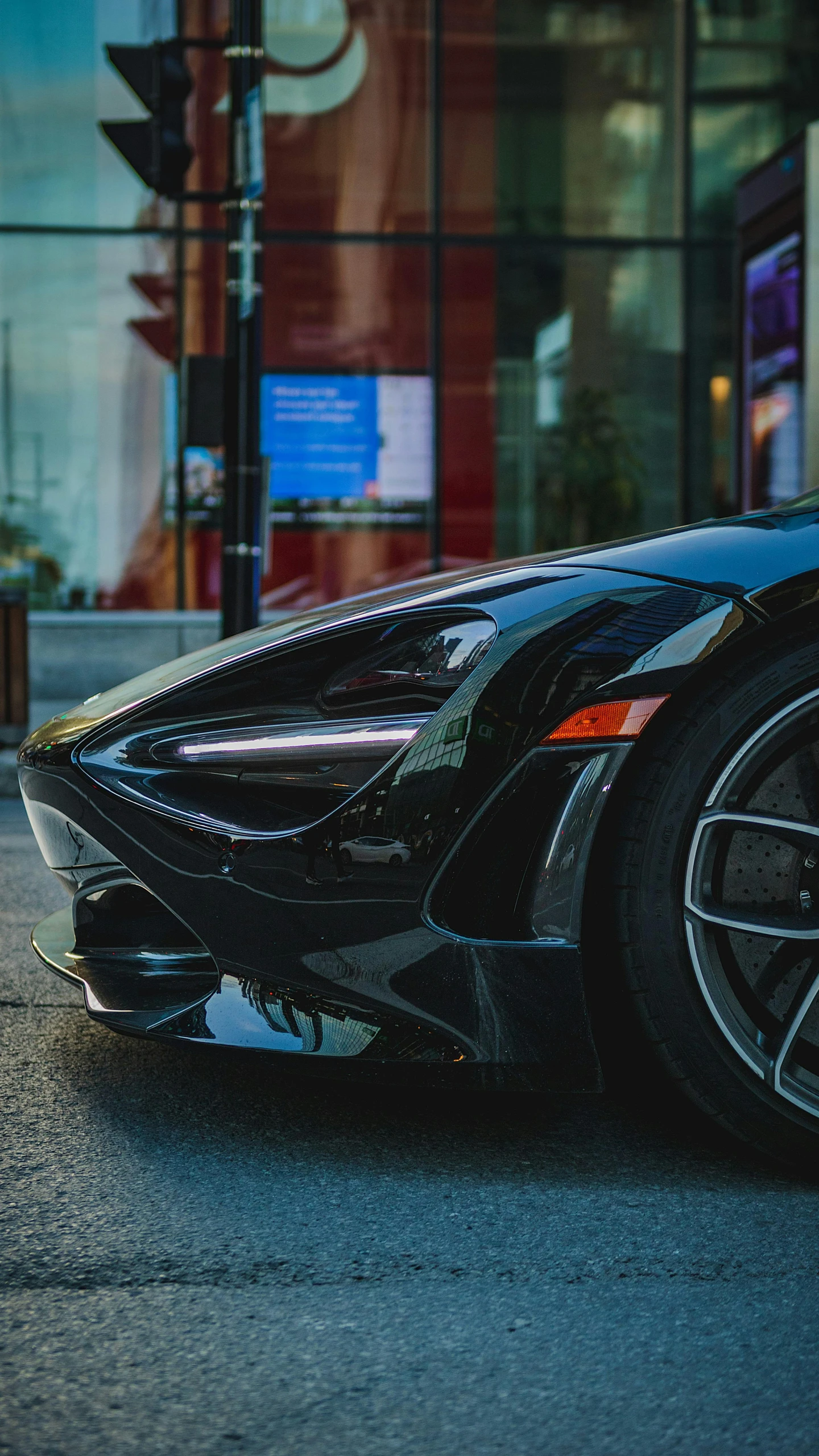 the black car is parked on the sidewalk