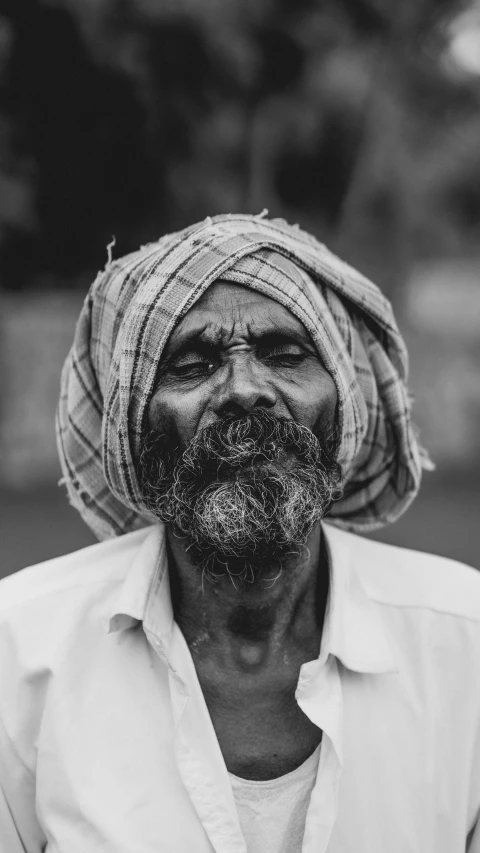 the man is wearing a turban and has his eyes closed