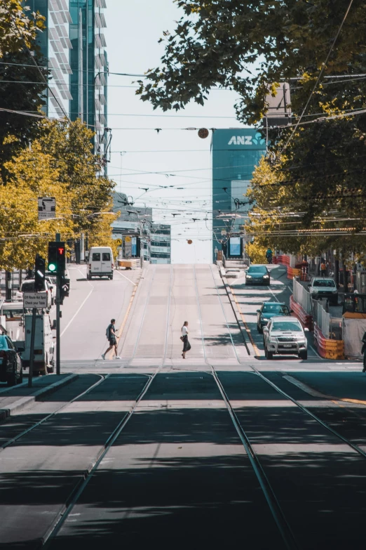 the crosswalk with street cars and people are shown