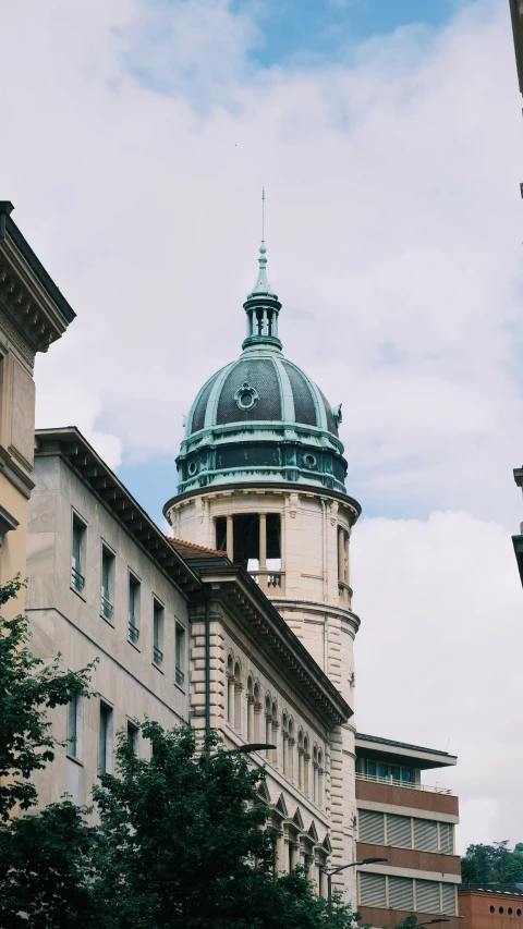 some large buildings with trees and a large clock