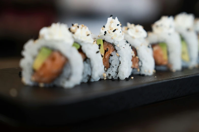 a tray of sushi sitting on top of a counter