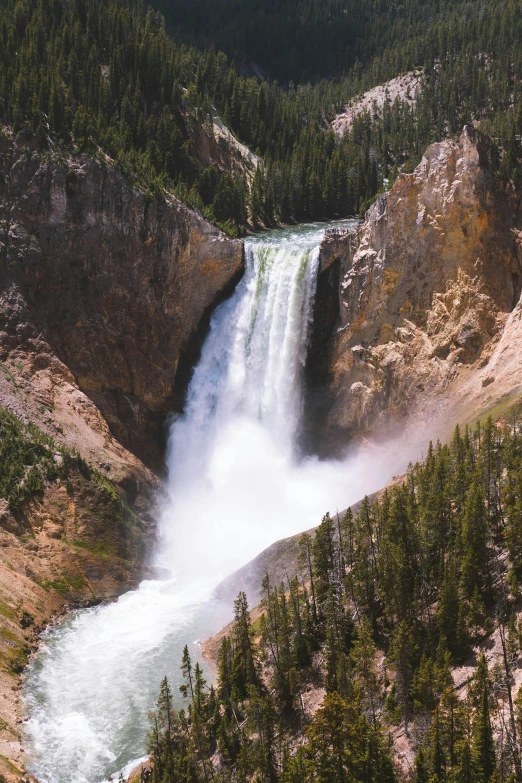 a river with trees on either side and falls coming out from the side