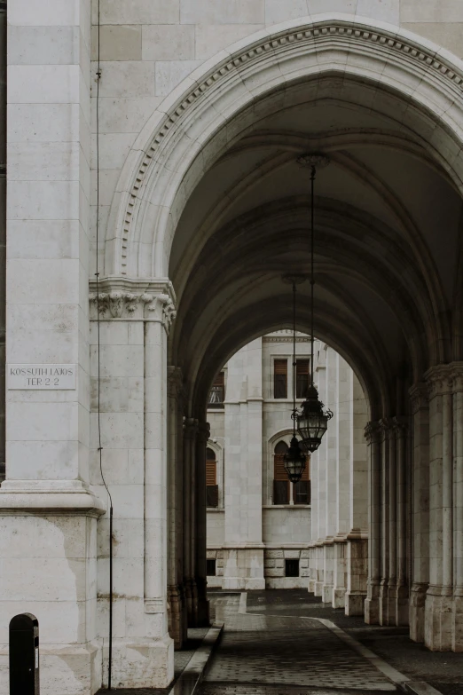 a building with pillars and light fixtures on either side of it