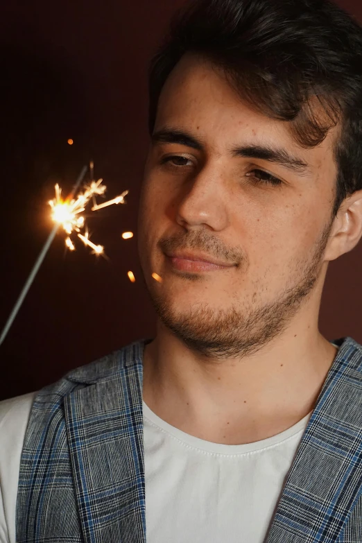 a man is looking at the sparkler