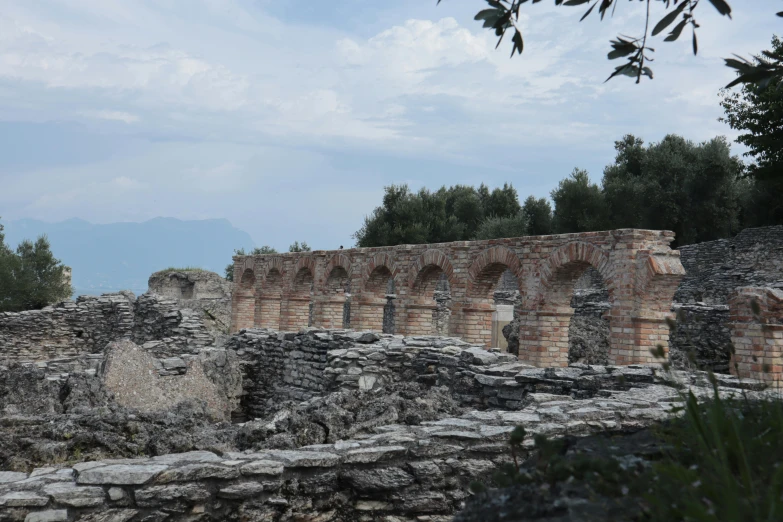 there are ruins and a horse in the distance