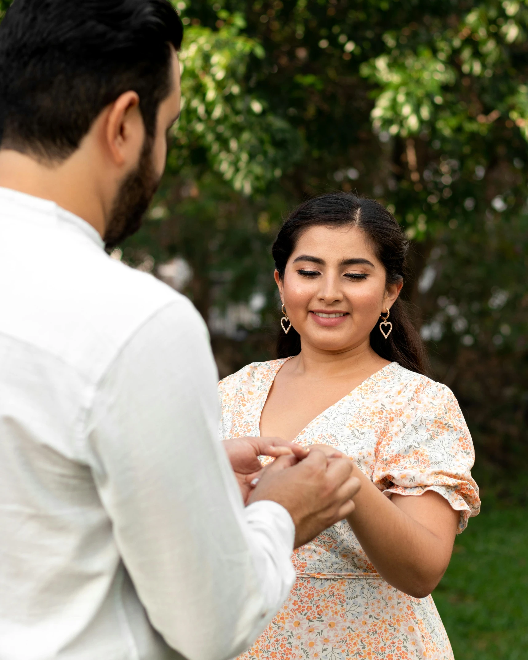 man putting wedding ring on the bride's finger