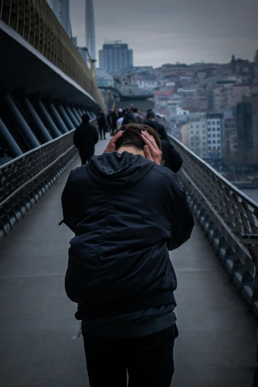 a person walking across a bridge with a very bad looking building