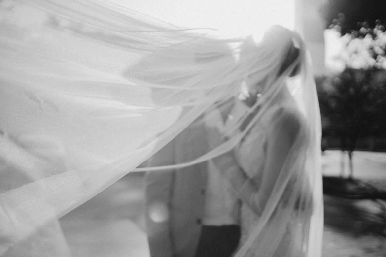 black and white pograph of a bride's veil in motion