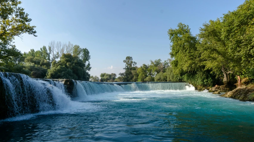 a waterfall is shown, with a river running beside it