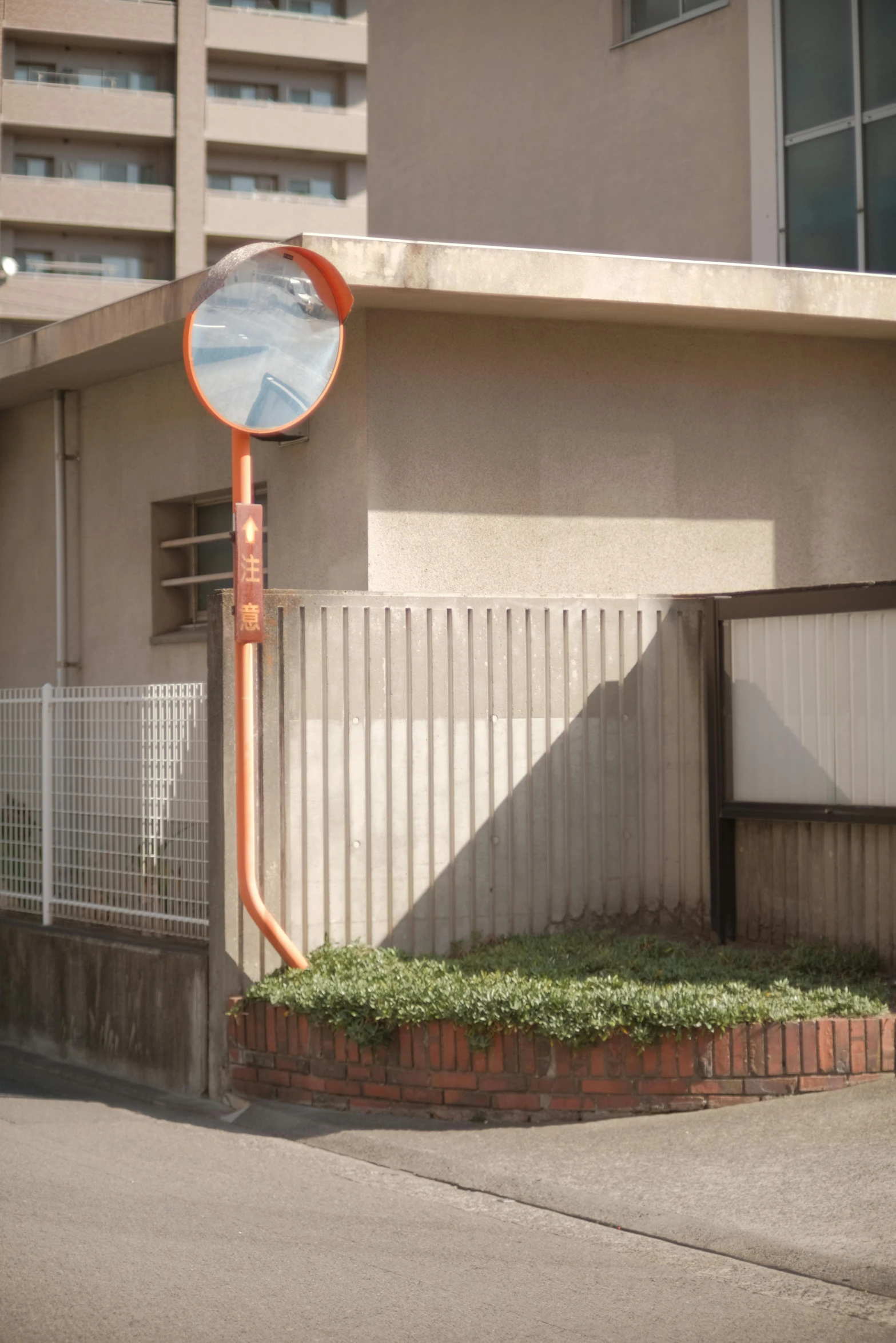 a clock in front of a building on the side walk