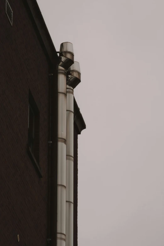 a large pillar is next to a building