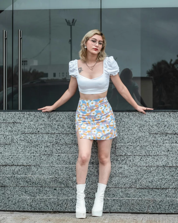 the woman is posing in front of a building