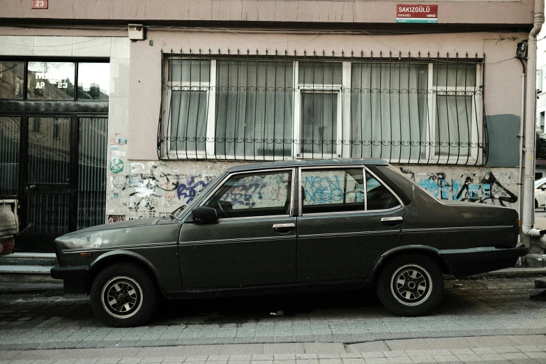 a dark colored car parked on the side of the street