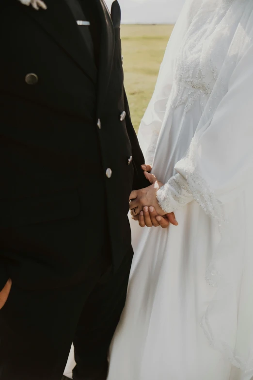 man in a suit holding the hand of a woman