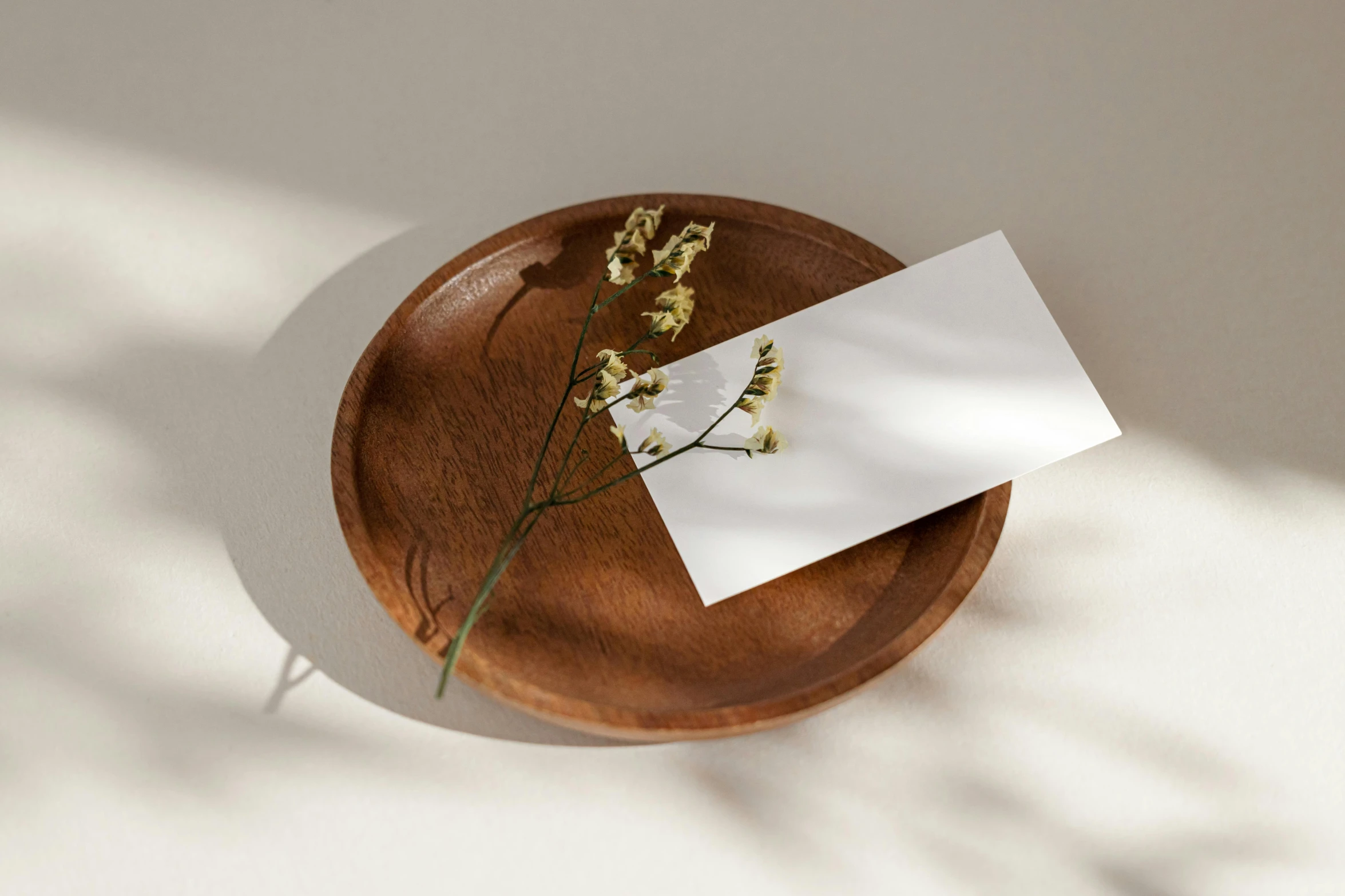 flowers in paper are on a wooden plate