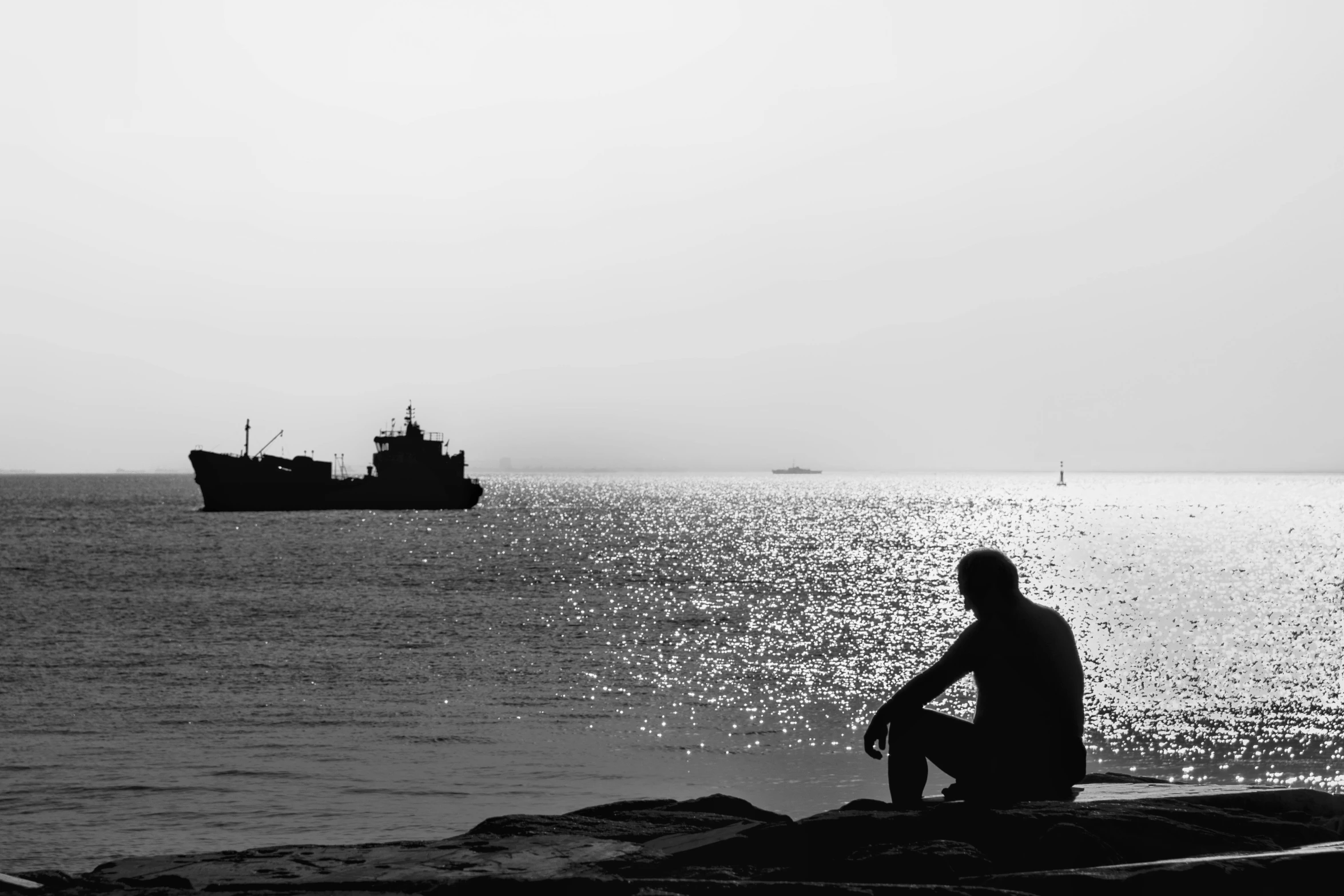 a black and white po of a man and a boat