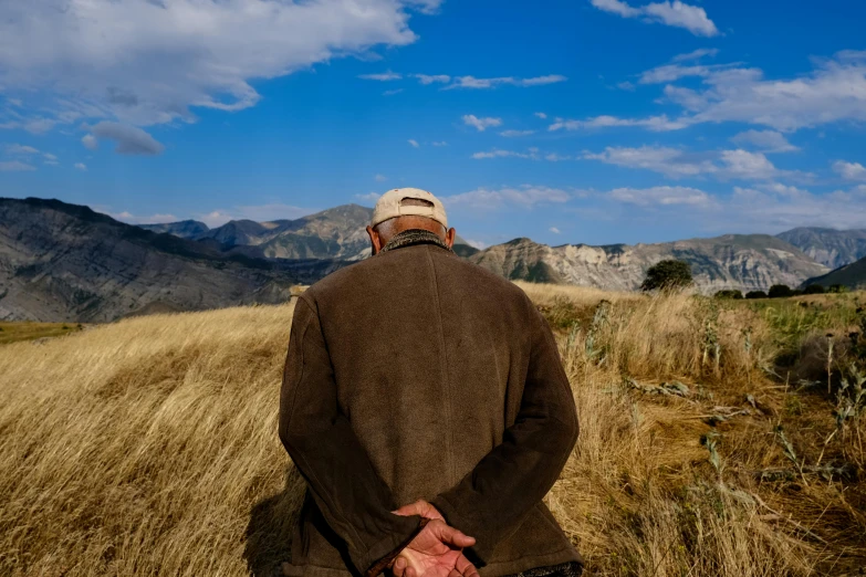 a person standing on top of a grass covered field