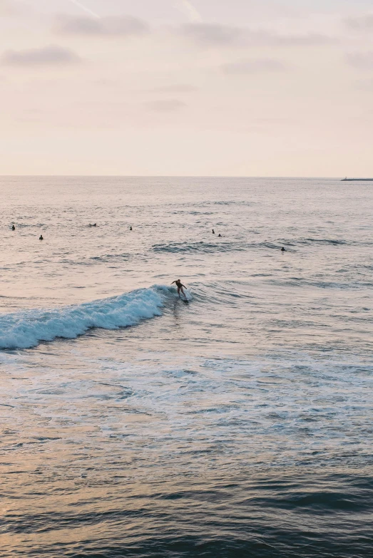 a lone surfer riding the surfboard in a large body of water