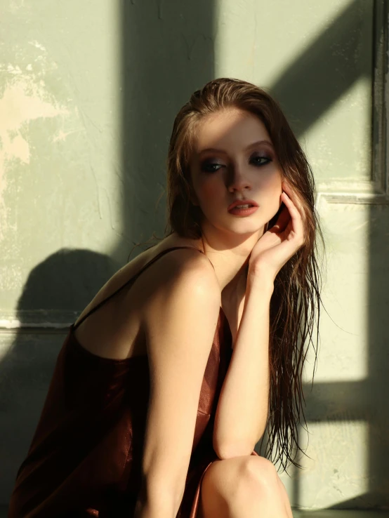 woman sitting on step with sun shining behind her