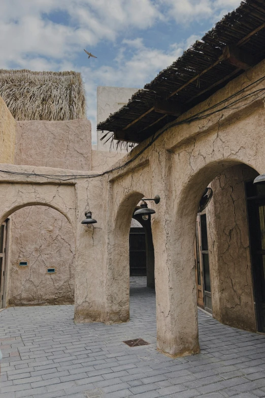 an open courtyard of a building with stone arches