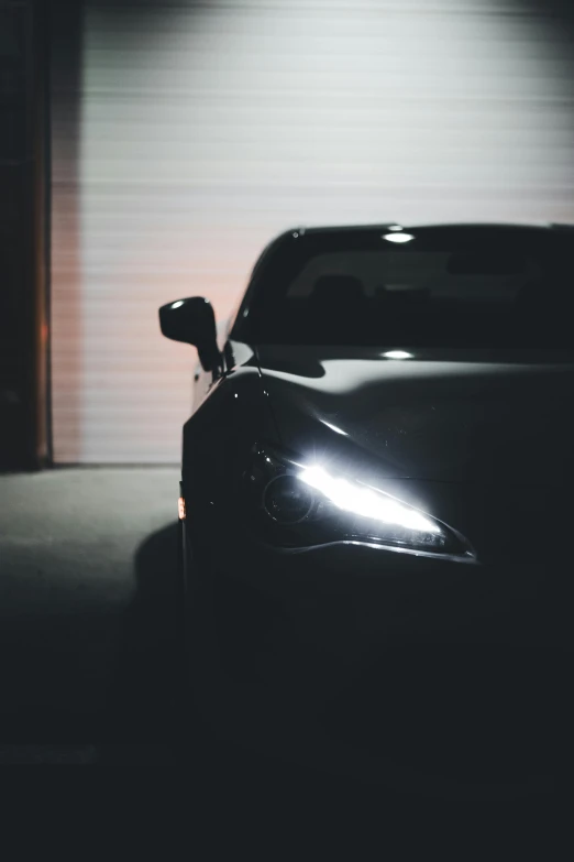 a parked sports car at night in front of a building