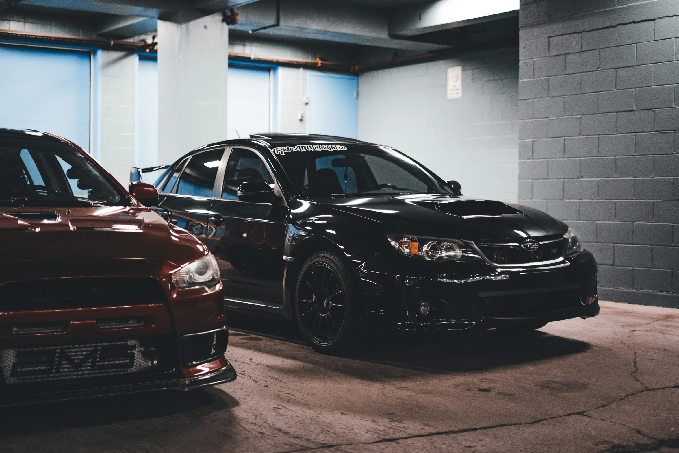 a line up of cars parked in an underground garage