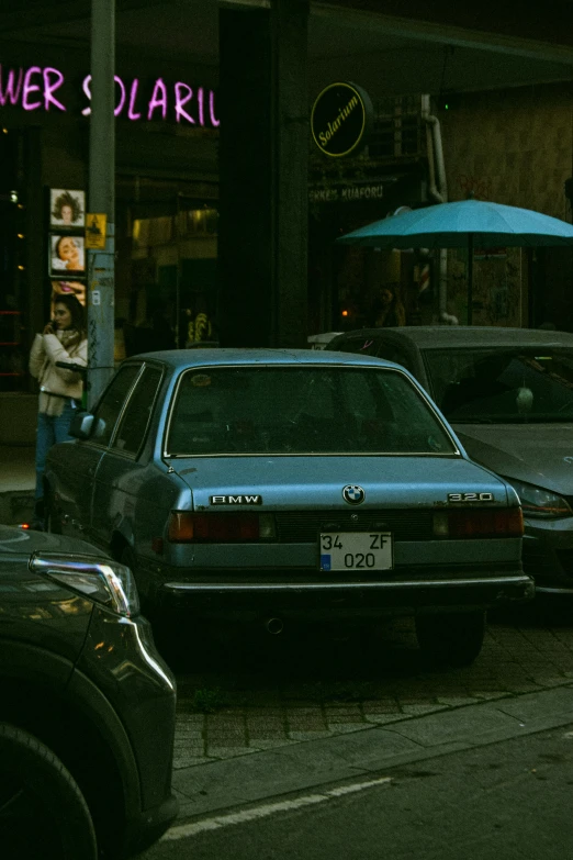 cars are parked on the side of the road in front of the shop