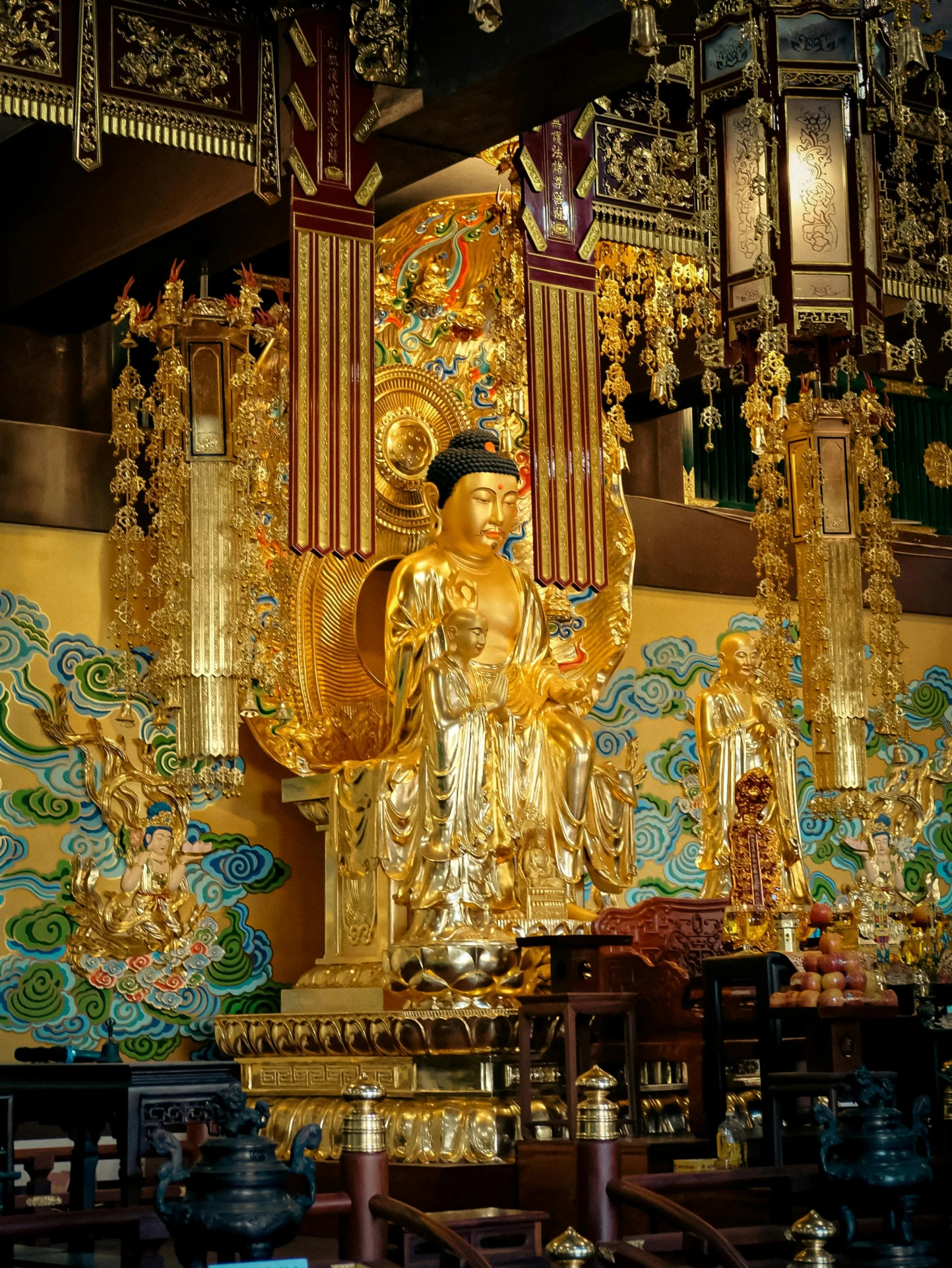 an asian shrine with a gold statue next to it