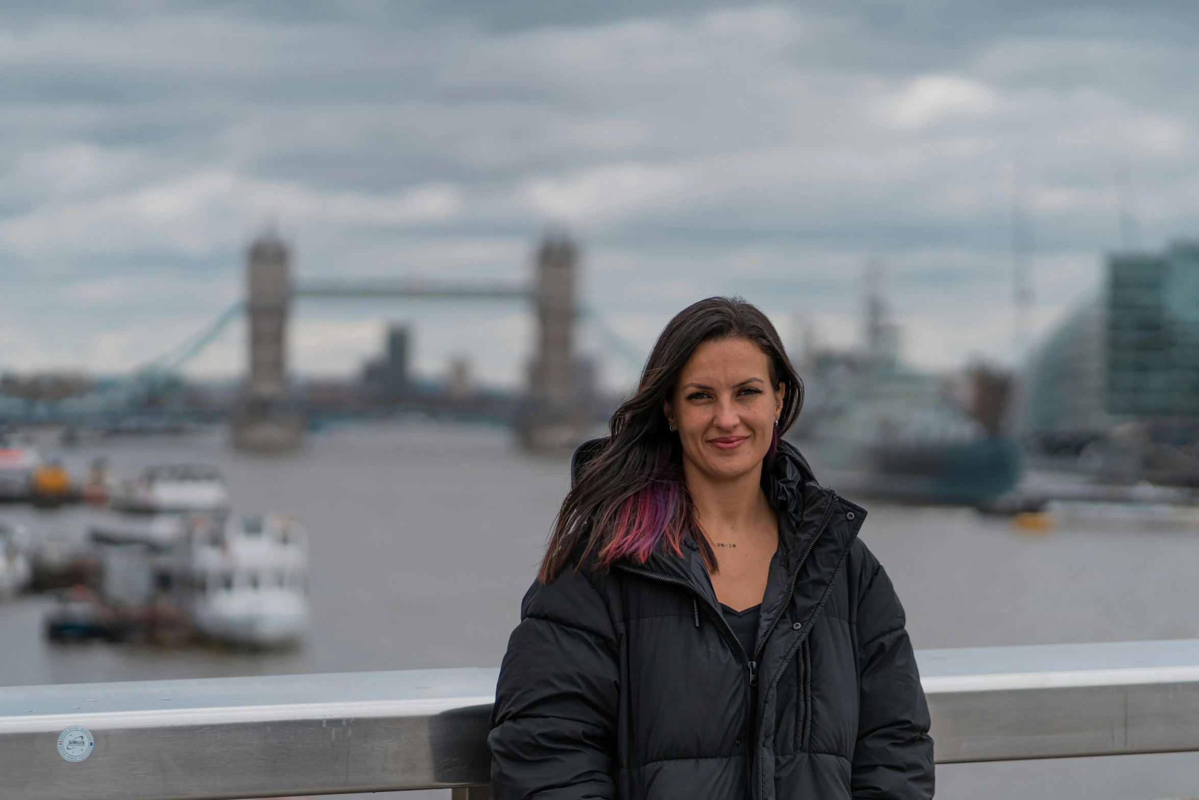 a woman standing next to a metal wall